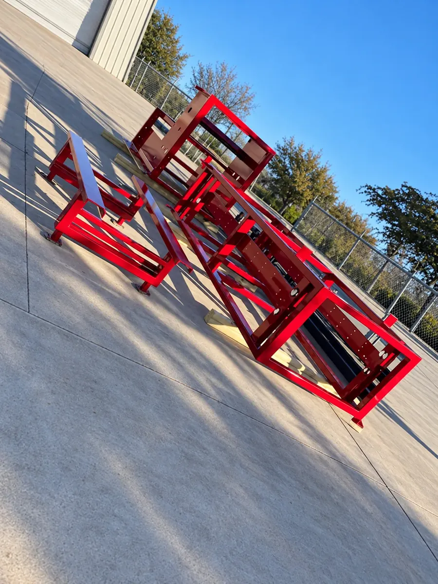 Multiple fabricated frames finished in candy red over Bengal silver powder coating